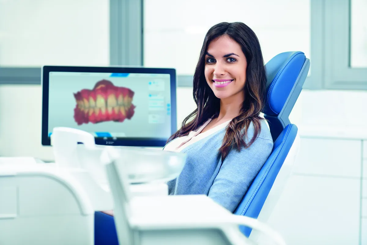 Paciente sorrindo ao lado do resultado do escaneamento 3D